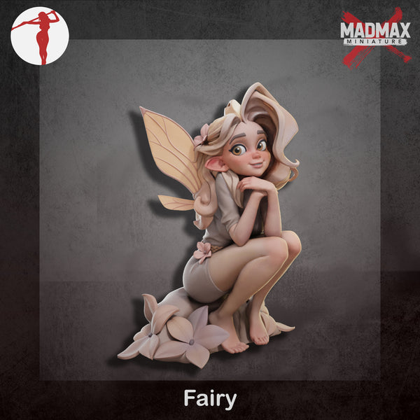 a figurine of a fairy sitting on a rock