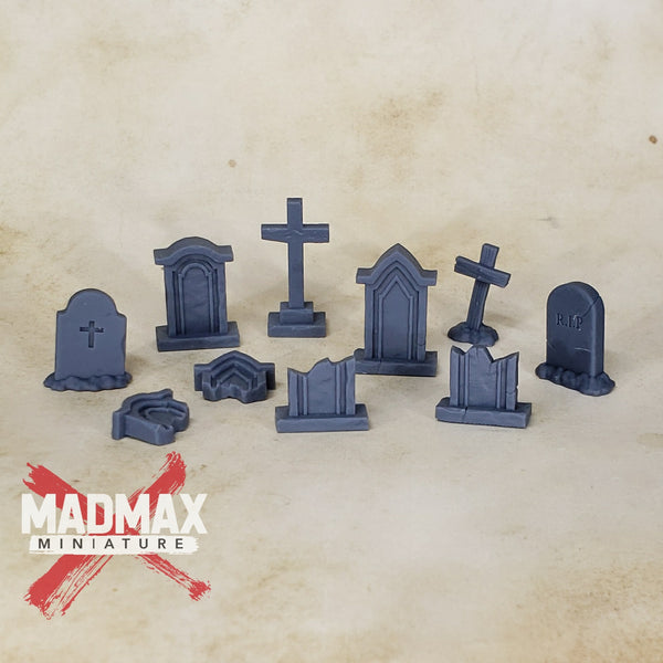 a bunch of tombstones and crosses on a table