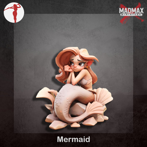 a statue of a mermaid sitting on top of a rock