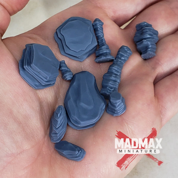 a hand holding a small group of blue plastic objects