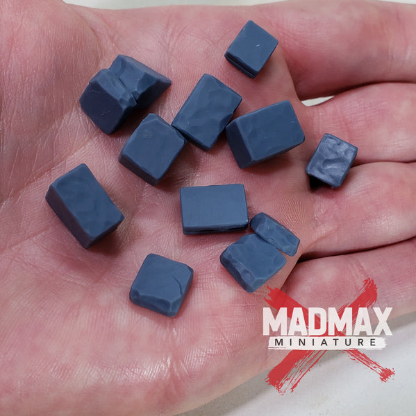 a hand holding a bunch of small blue cubes