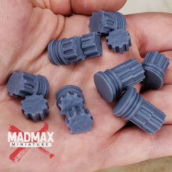 a hand holding a bunch of gray plastic gears