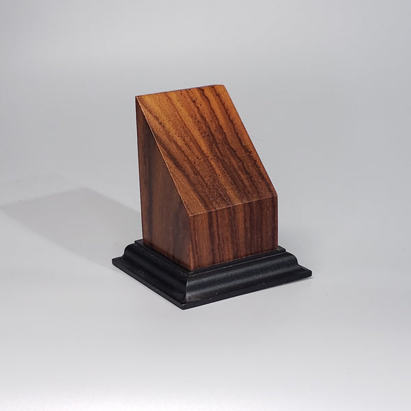 a wooden object with a black base on a white background