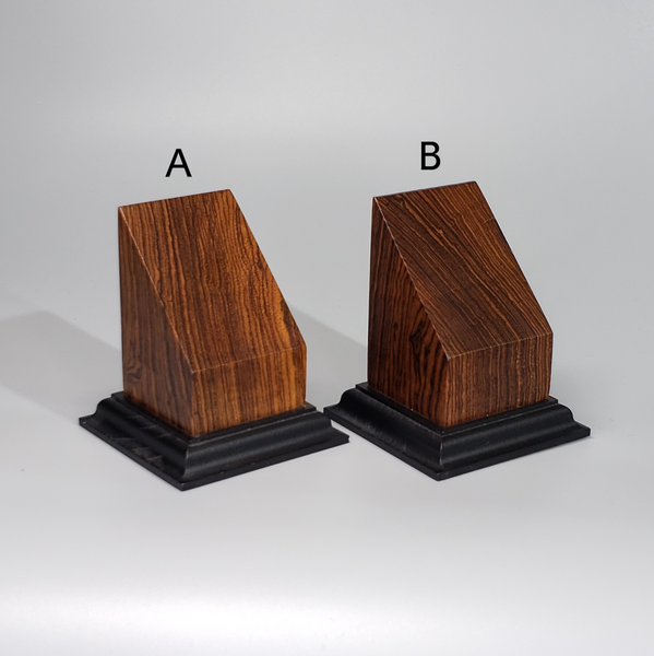 a pair of wooden blocks sitting on top of each other
