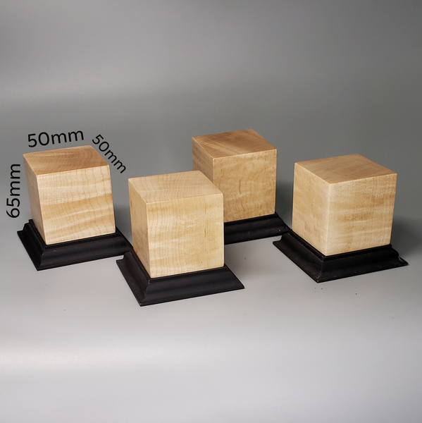 a group of wooden blocks sitting on top of a black stand