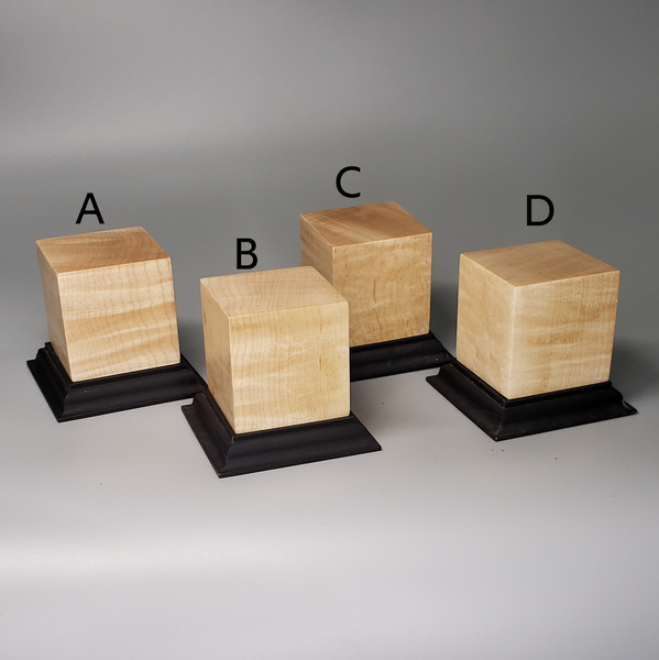 a group of wooden blocks sitting on top of a black stand
